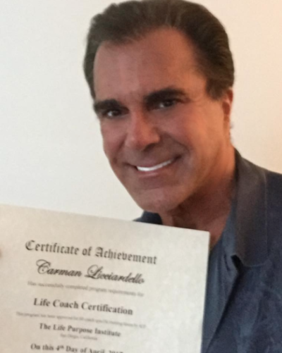 Carman Licciardello proudly holds up his life coach credentials, April 12, 2017.