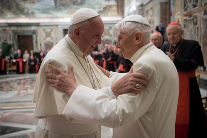 Pope Francis greets his predecessor Pope Emeritus Benedict XVI at the Vatican.