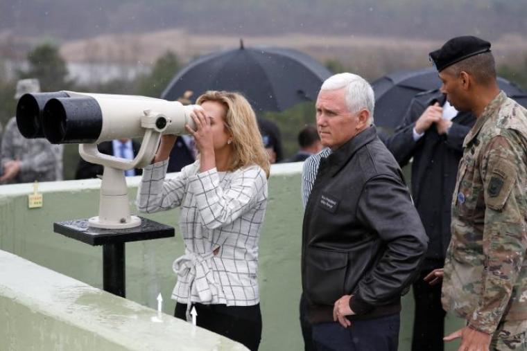 U.S. Vice President Mike Pence stands next to his daughter looking toward the north through a pair of binocular from an observation post inside the demilitarized zone separating the two Koreas, in Paju, South Korea, April 17, 2017.