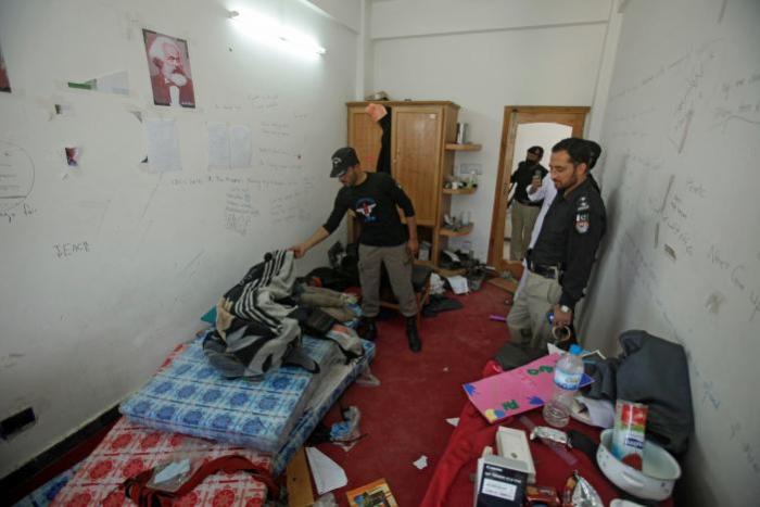 Police search the dorm room of Mashal Khan, accused of blasphemy, who was killed by a mob at Abdul Wali Khan University in Mardan, Pakistan April 14, 2017.