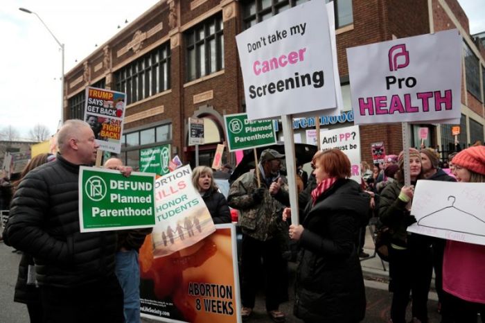Supporters of Planned Parenthood (R) rally next to anti-abortion activists outside a Planned Parenthood clinic in Detroit, Michigan, U.S. on Feb. 11, 2017.