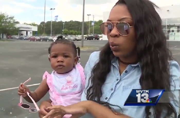 Danetris Caves holds her 11-month-old daughter Karleigh who escaped death Saturday April 15, 2017, after she was shot while attending a spring carnival at the Cathedral of the Cross Church of God in Birmingham, Alabama.