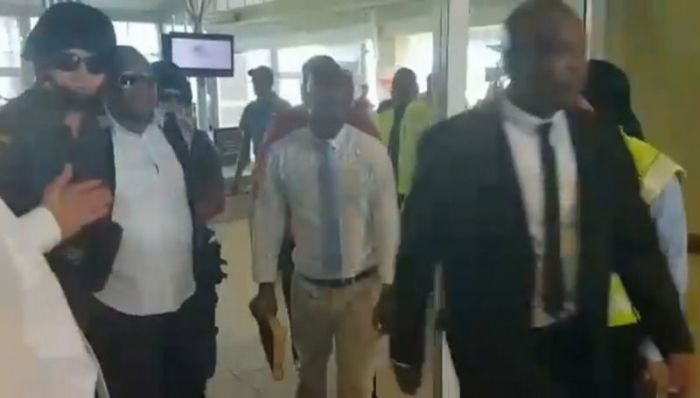 Pastor Timothy Omotoso being led out by police at Port Elizabeth Airport in South Africa on April 20, 2017.