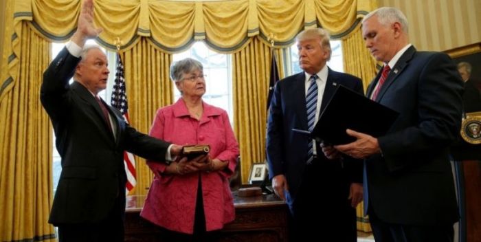 U.S. President Donald Trump watches as Vice President Mike Pence (R) swears in Jeff Sessions (L) as U.S. Attorney General while his wife Mary Sessions holds the Bible in the Oval Office of the White House in Washington February 9, 2017.