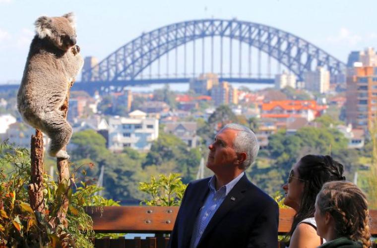 U.S. Vice President Mike Pence looks at a koala with his daughters Charlotte and Audrey and a keeper during a visit to Taronga Zoo in Sydney, Australia, April 23, 2017.