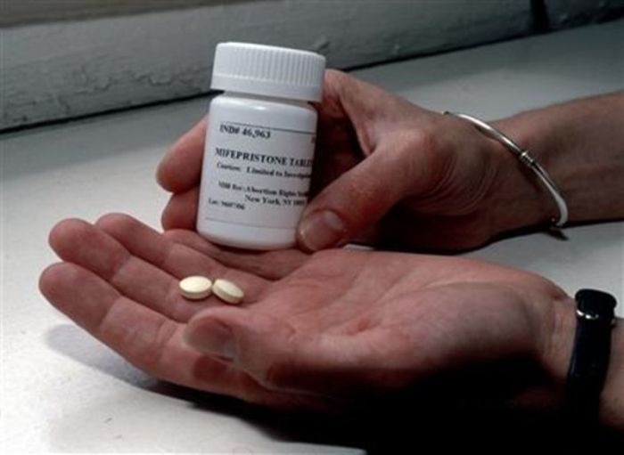 A bottle and two pills of mifepristone, also known as RU-486, are seen in a handout photo.