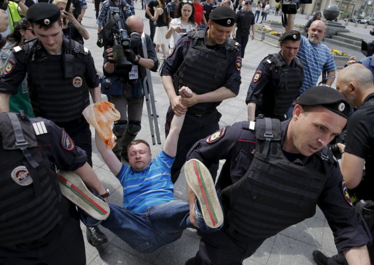 A gay rights activist is seen being detained by police during an LGBT community rally in Moscow in 2015.