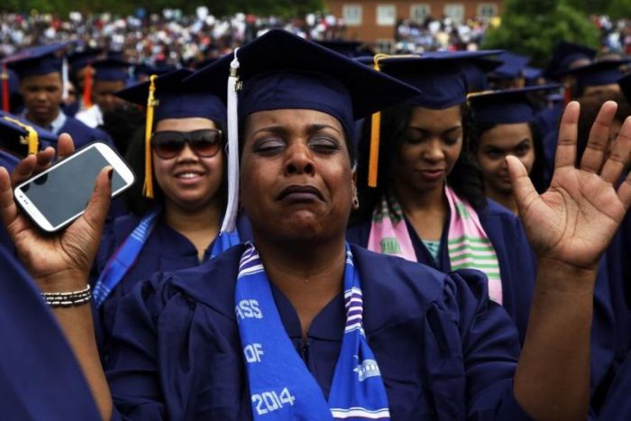 A graduate cries during a prayer at Howard University's 2014 graduation ceremonies in Washington, D.C.
