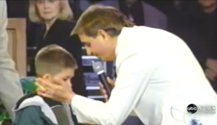 Televangelist Benny Hinn delivers a healing touch to William Vandenkolk at a Las Vegas Nevada service in 2001.