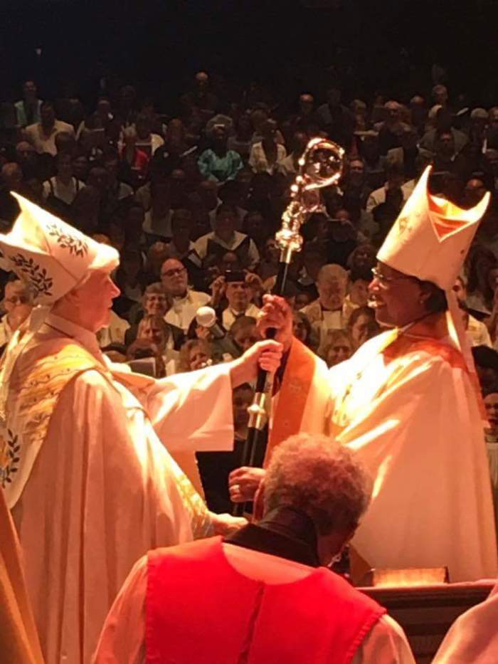 The Right Reverend Jennifer Baskerville-Burrows, 11th Bishop of the Episcopal Diocese of Indianapolis, receiving the Bishop's Crozier from the retiring The Right Reverend Catherine Waynick, 10th Bishop of the Episcopal Diocese of Indianapolis.