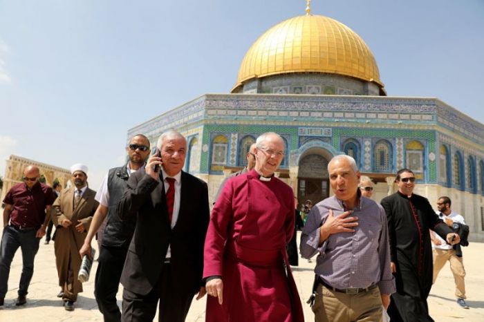 Archbishop of Canterbury Justin Welby (center) walks with Azzam al-Khatib (center, left), head of the Jordanian Waqf, or Islamic trust, that administers the compound known to Muslims as Noble Sanctuary and to Jews as Temple Mount, during a visit to the Dome of the Rock on the site in Jerusalem's Old City on May 3, 2017.