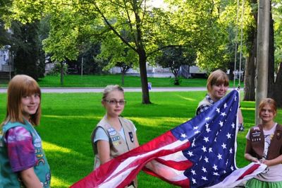 Girl Scouts raising the flag at a Municipal Band concert in Eau Claire, Wisconsin.