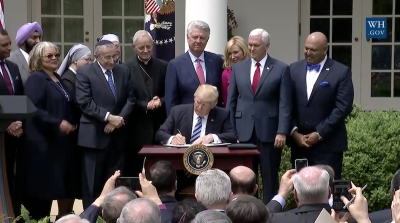 President Donald Trump signs an executive order on religious liberty at the White House, May 4, 2017.