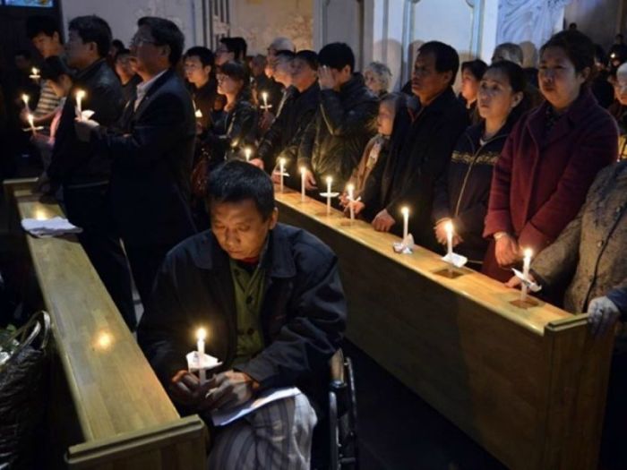 Chinese believers express their faith during a church service.