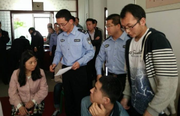 Chinese police officials interrogate participants in a Christian gathering after a raid.
