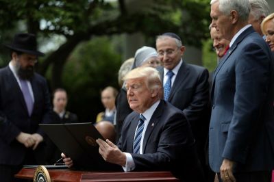 U.S. President Donald Trump prepares to sign the Executive Order on Promoting Free Speech and Religious Liberty during the National Day of Prayer event at the Rose Garden of the White House in Washington D.C., U.S., on May 4, 2017.