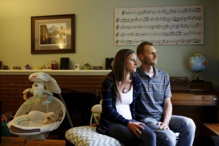 Emily and Matt Knudsen sit in their living room in their home in Fremont, California, May 14, 2015.