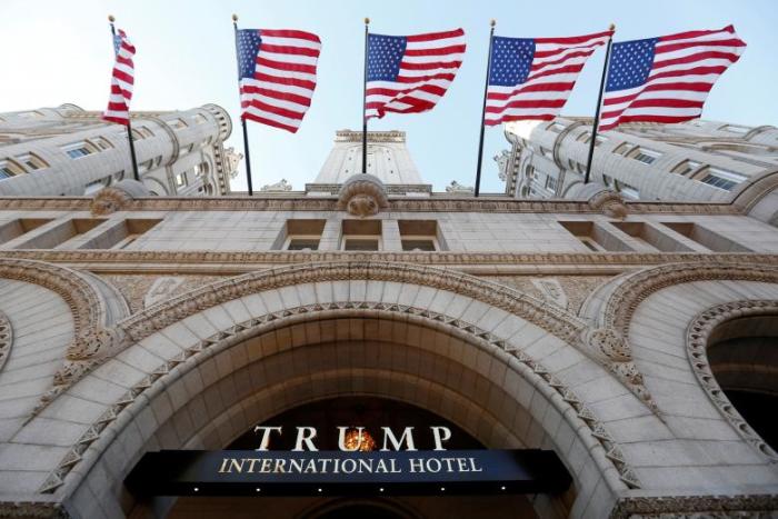Flags fly above the entrance to the new Trump International Hotel on its opening day in Washington, DC, U.S. on Sept. 12, 2016.