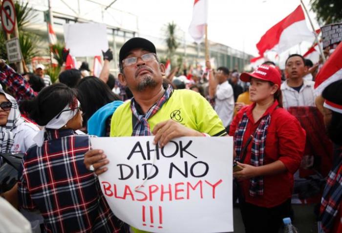 Supporters of Jakarta Governor Basuki Tjahaja Purnama, also known as Ahok, stage a protest outside Cipinang Prison, where he was taken following his conviction of blasphemy, in Jakarta, Indonesia, May 9, 2017.