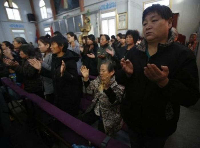 Chinese Christians pray at an underground church in Tianjin.