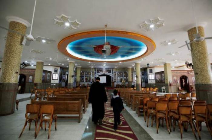 A Christian boy walks with a priest who left with his family from Al-Arish city North Sinai's Governorate capital after the escalation of a campaign targeting Christians by Islamic State militants last week, walks inside the Saint Church in Ismailia, northeast of Cairo, Egypt February 27, 2017.