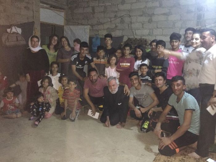 Pastor William Devlin in unfinished building in Sharya, Kurdistan with Yazidi families who have lived in an abandoned, unfinished building for 3 years with no running water or heat; photo posted May 13, 2017.