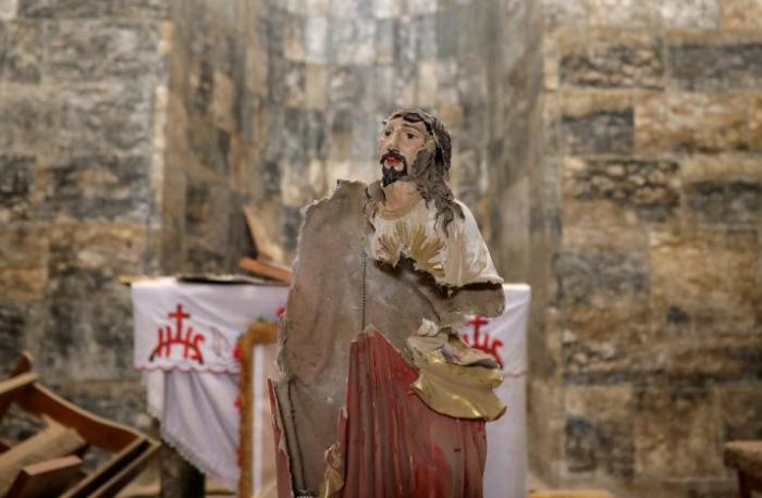 A damaged statue of Jesus Christ is seen inside a church in the town of Qaraqosh, south of Mosul, Iraq, April 11, 2017.