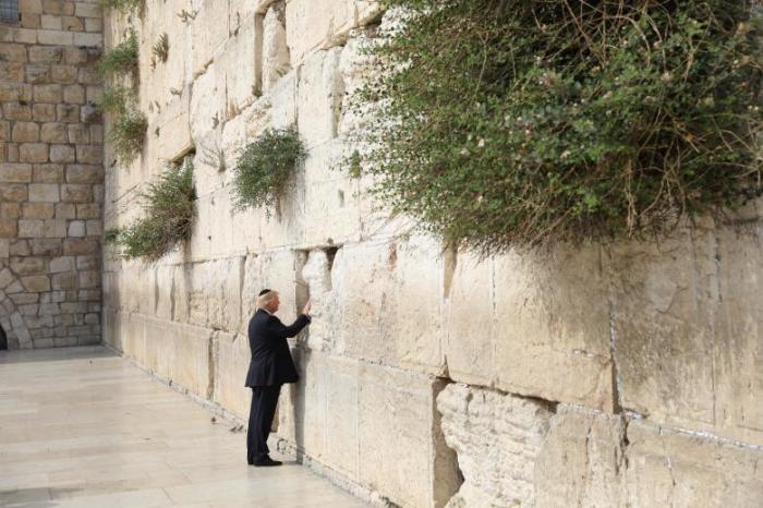 U.S. President Donald Trump touches the Western Wall, Judaism's holiest prayer site, in Jerusalem's Old City May 22, 2017.