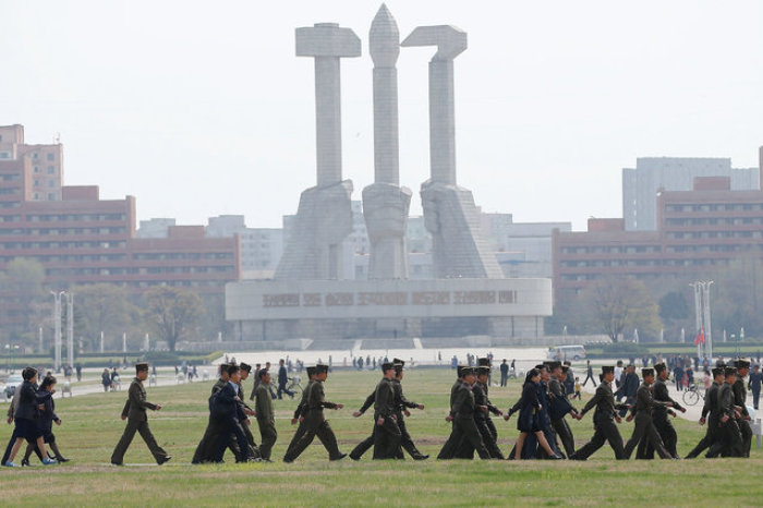 Soldiers walk in front of the Monument to the Foundation of the Workers' Party in Pyongyang, North Korea April 16, 2017.