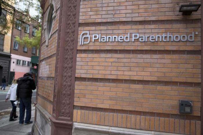 People walk past a Planned Parenthood clinic in the Manhattan borough of New York, November 28, 2015.