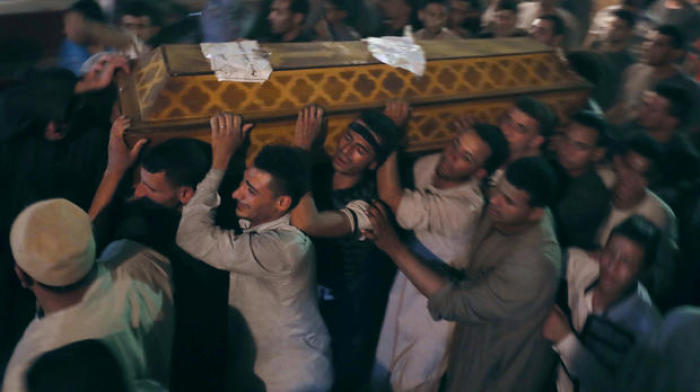 Mourners carry a coffin at the funeral of Coptic Christians who were killed in Minya, Egypt, May 26, 2017.