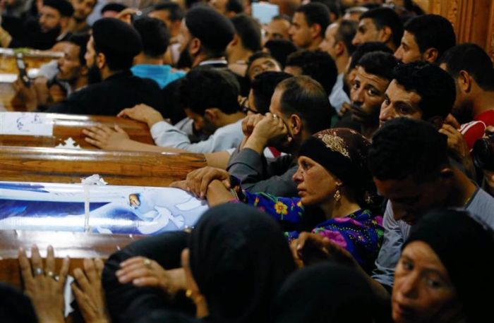 Mourners gather at the Sacred Family Church for the funeral of Coptic Christians in Minya.