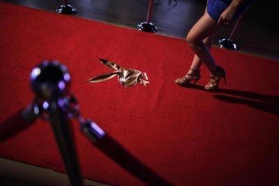 A young woman walks towards a stage to be photographed while applying for a job as a Playboy bunny during a casting in Monterrey August 7, 2013.