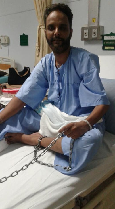 Asylum seeker Ijaz Paras Masih sits in a hospital bed in Thailand in this undated photo.