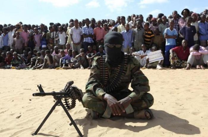 A member of Somalia's al-Shabaab militant group sits during a public demonstration to announce their integration with al Qaeda, in Elasha, south of the capital Mogadishu, February 13, 2012.