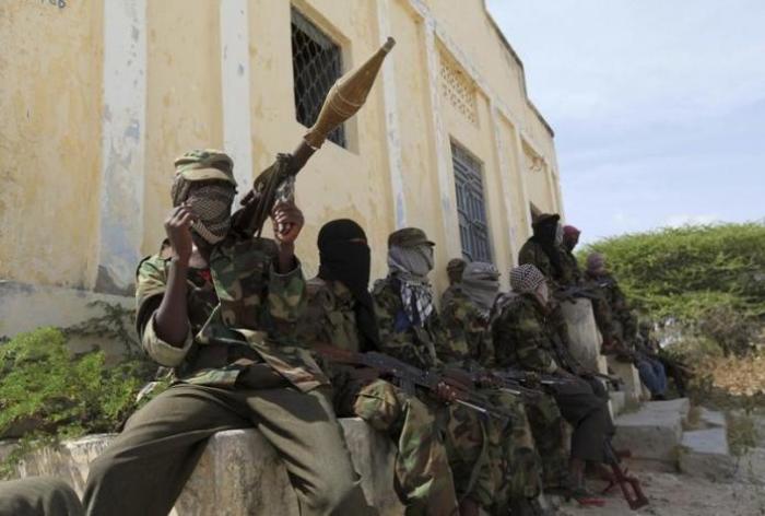 Al Shabaab soldiers sit outside a building during patrol along the streets of Dayniile district in Southern Mogadishu, March 5, 2012.
