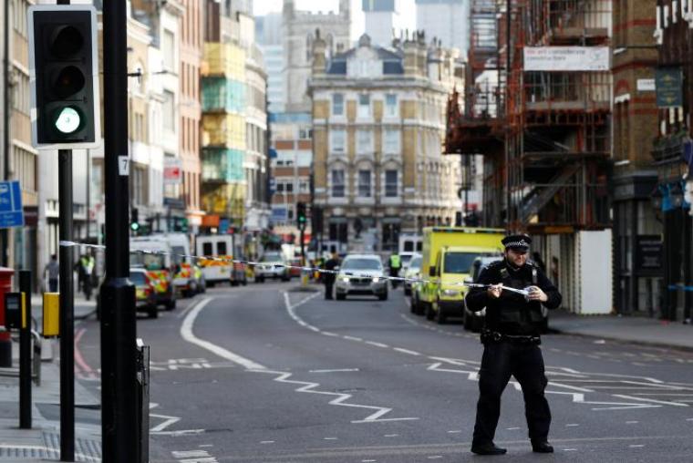 A police officer stretches cordon tape across the road near Borough Market after an attack left seven people dead and dozens injured in London, Britain, June 4, 2017.