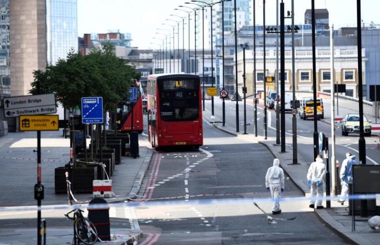 Police forensics investigators work on London Bridge near abandoned buses after an attack left seven people dead and dozens injured in London, Britain, June 4, 2017.