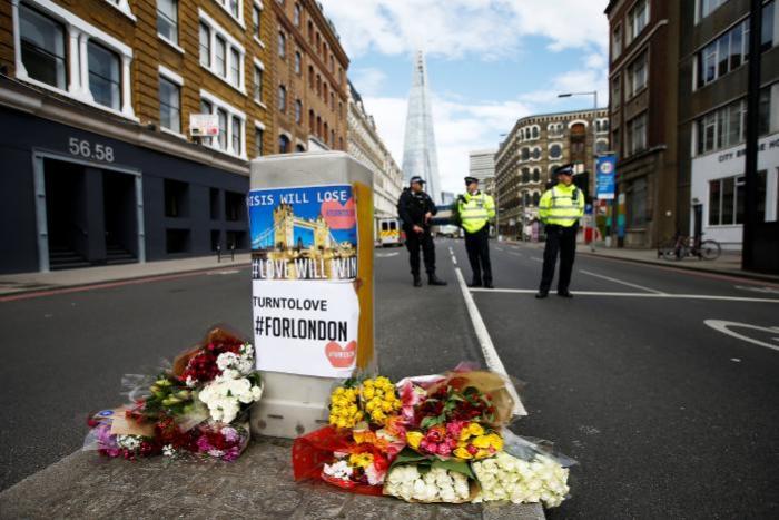 Flowers and messages lie behind police cordon tape near Borough Market after an attack left 7 people dead and dozens injured in London, Britain, June 4, 2017.
