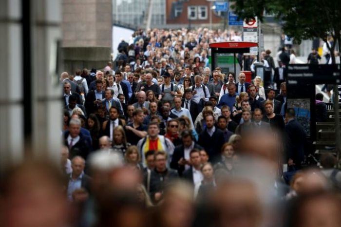 Commuters walk across London Bridge after is was reopened following an attack which left 7 people dead and dozens of injured in central London, Britain, June 5, 2017.