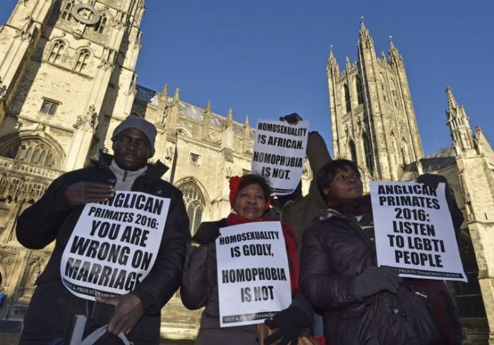 Gay rights campaigners protest in the grounds of Canterbury Cathedral in Canterbury during the Anglican Primates meeting in January 2016.