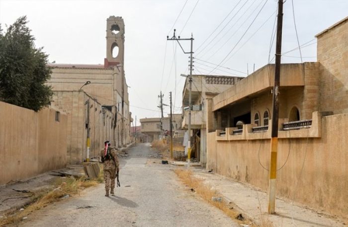 An Iraqi soldier walks the near-empty streets of Qaraqosh, Iraq after the predominantly Christian city was liberated from ISIS in December 2016.
