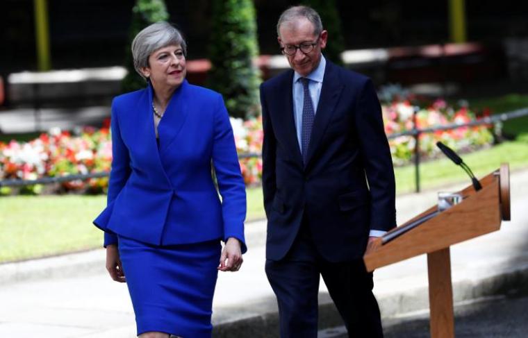 Britain's Prime Minister Theresa May returns to Downing Street with her husband Philip after traveling to Buckingham Palace to ask the Queen's permission to form a minority government, in London, June 9, 2017.