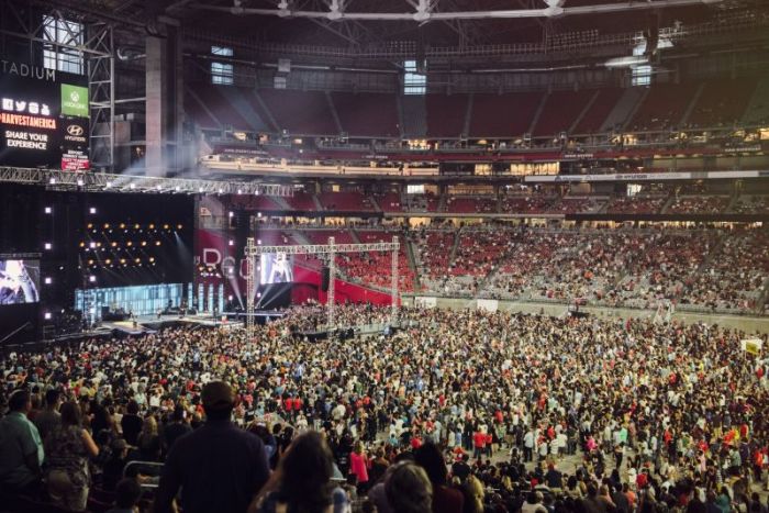 Thousands respond to the call to accept Jesus Christ at Harvest America at the University of Phoenix Stadium on June 11, 2017.