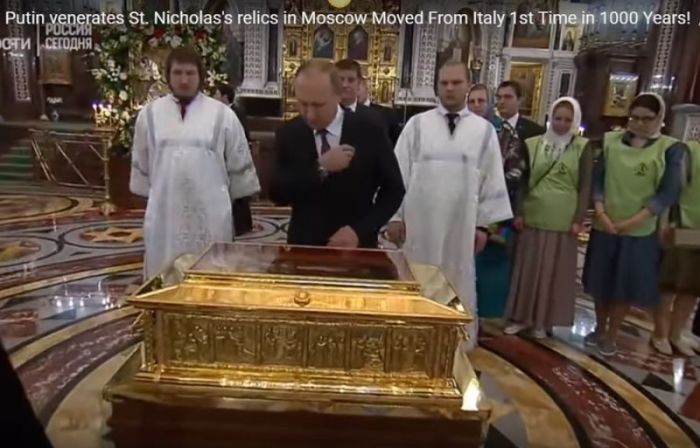Russian President Vladimir Putin makes the sign of the cross as he venerates the relic of St. Nicholas in Moscow's Christ the Savior Cathedral.