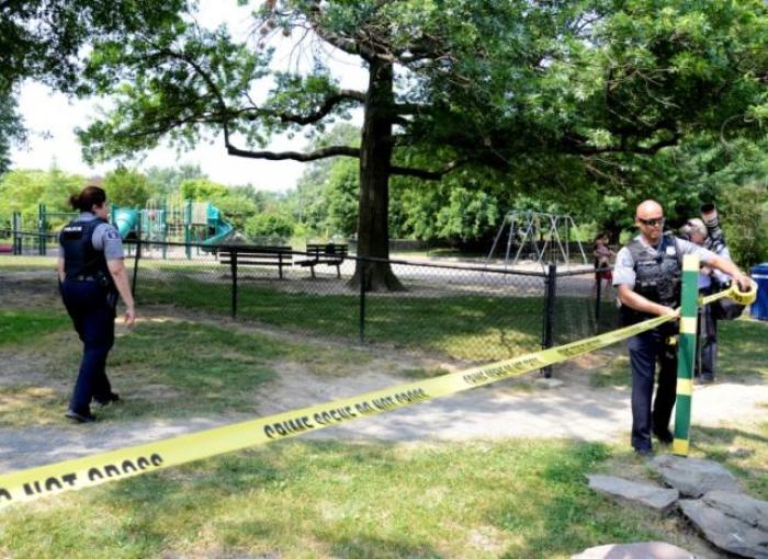 Police put up tape to clear journalists from the outfield area of a baseball field where shots were fired during a congressional baseball practice, wounding House Majority Whip Steve Scalise (R-LA), in Alexandria, Virginia on June 14, 2017.