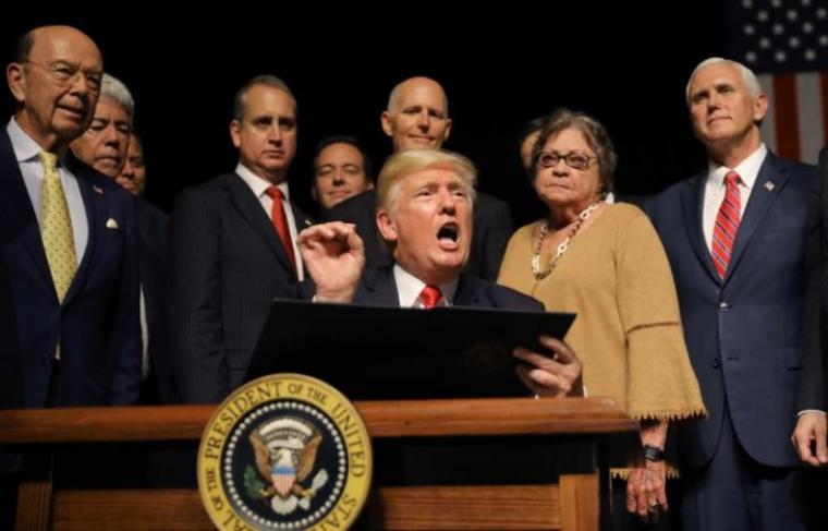 U.S. President Donald Trump speaks as he signs an executive order reversing Obama administration Cuba policies after Trump addressed US-Cuba relations at the Manuel Artime Theater in Miami, Florida, U.S., June 16, 2017.