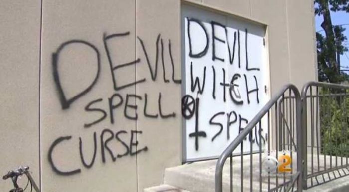 Anti-Christian graffiti spray-painted by unknown vandals is seen on the exterior wall of the New Covenant Church in Long Island, New York.