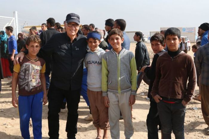 Vernon Brewer with kids in Iraq.