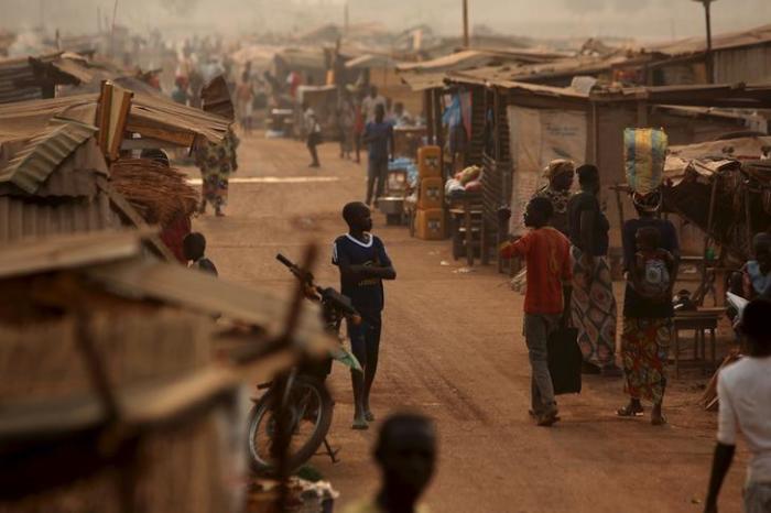 A boy walks in a camp sheltering internally displaced people (IDPs) next to the M'Poko international airport in Bangui, Central African Republic, February 13, 2016.